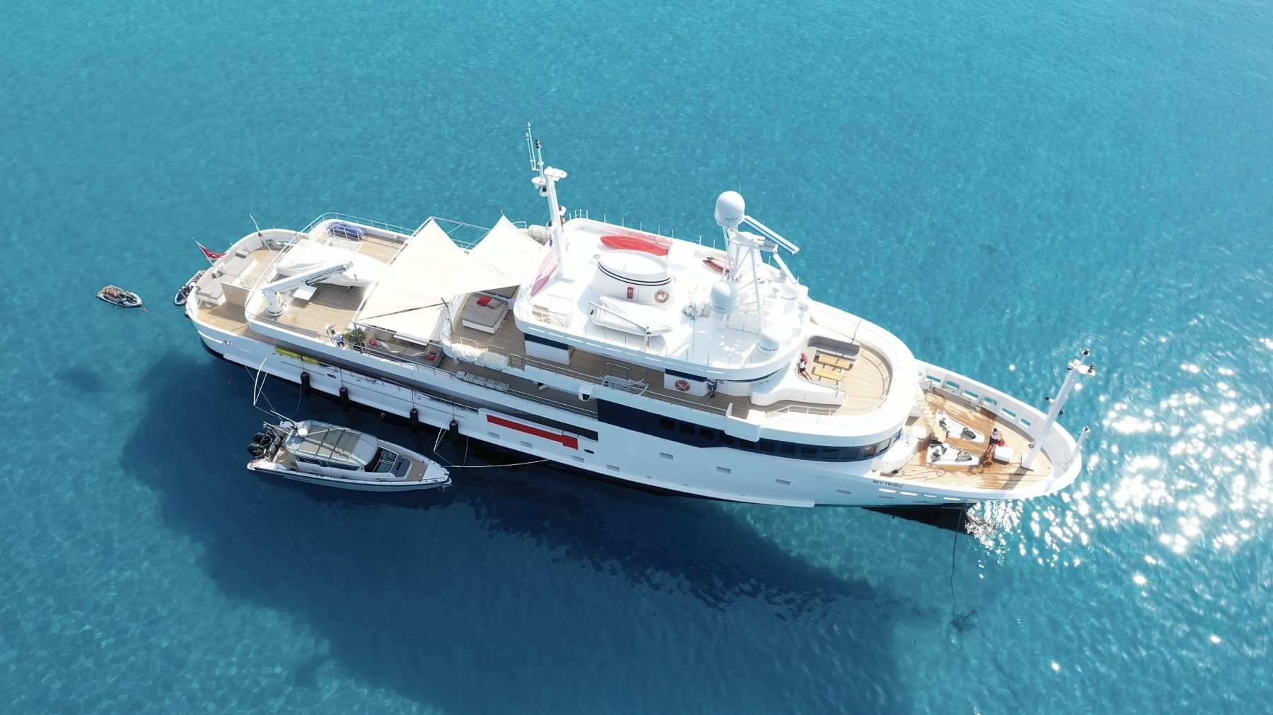 Luxury yacht with professional crew at anchor